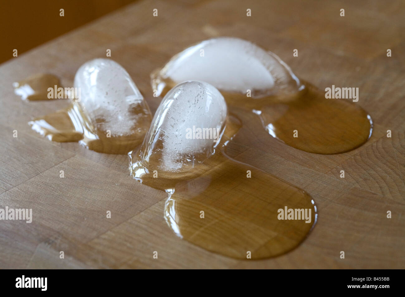 Melting ice cubes on counter top Stock Photo