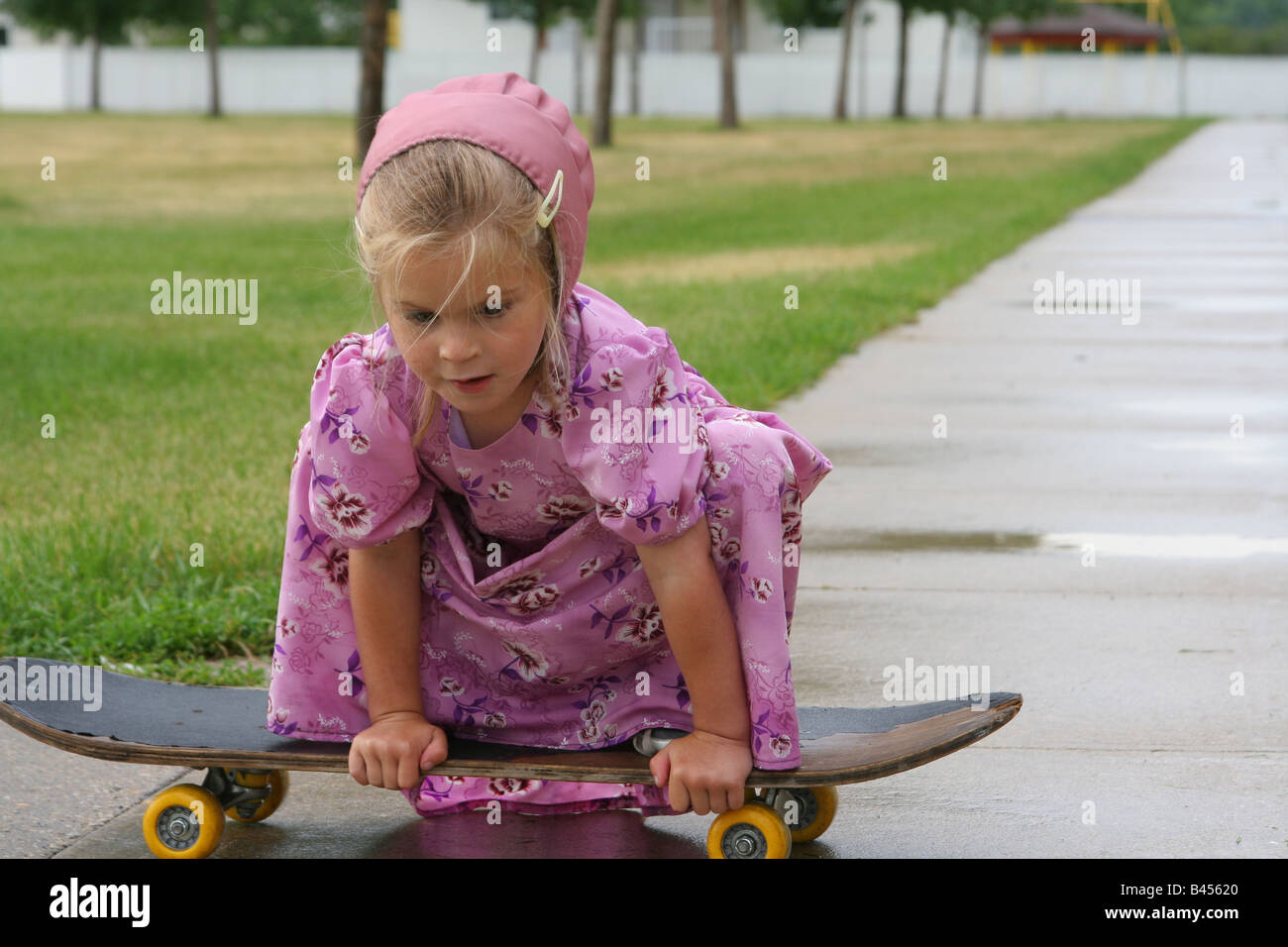 A Hutterite child enjoys the outdoors after a rainfall Stock Photo