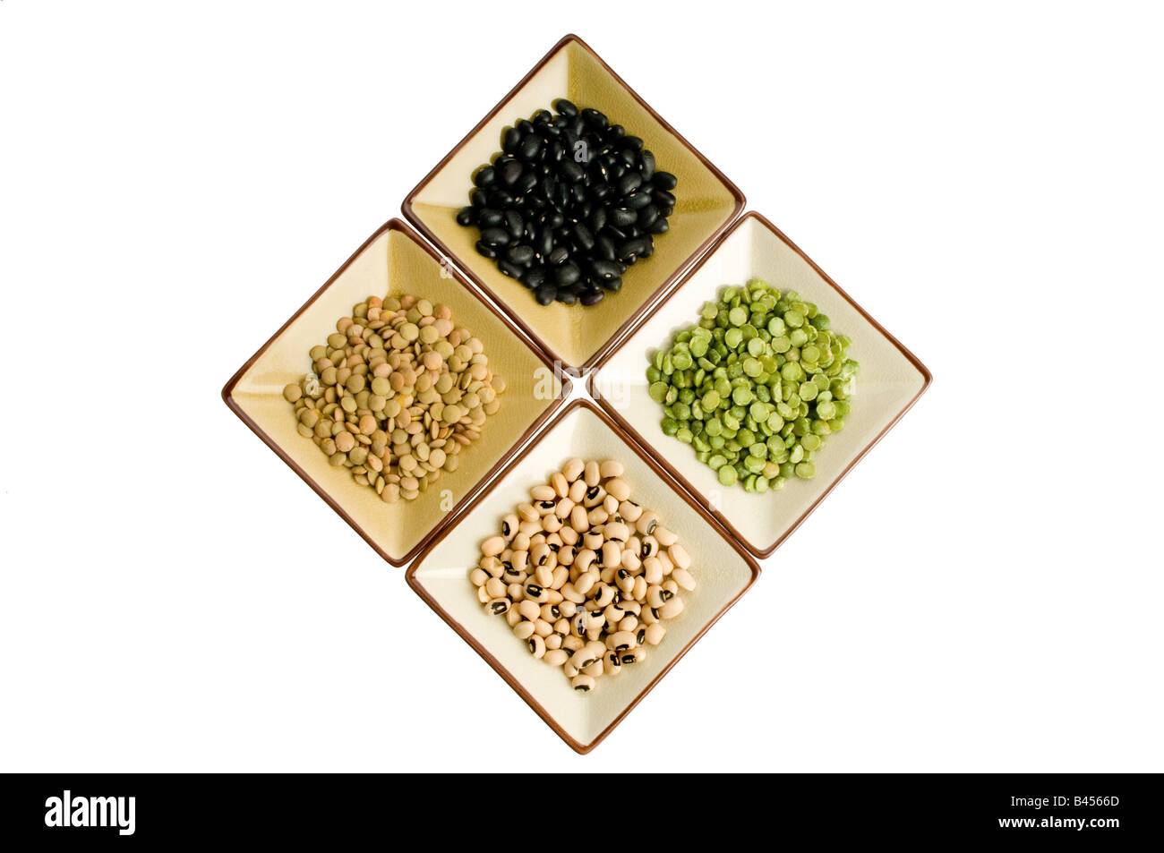 Four plates with lentils, black beans, black eyed peas, split peas