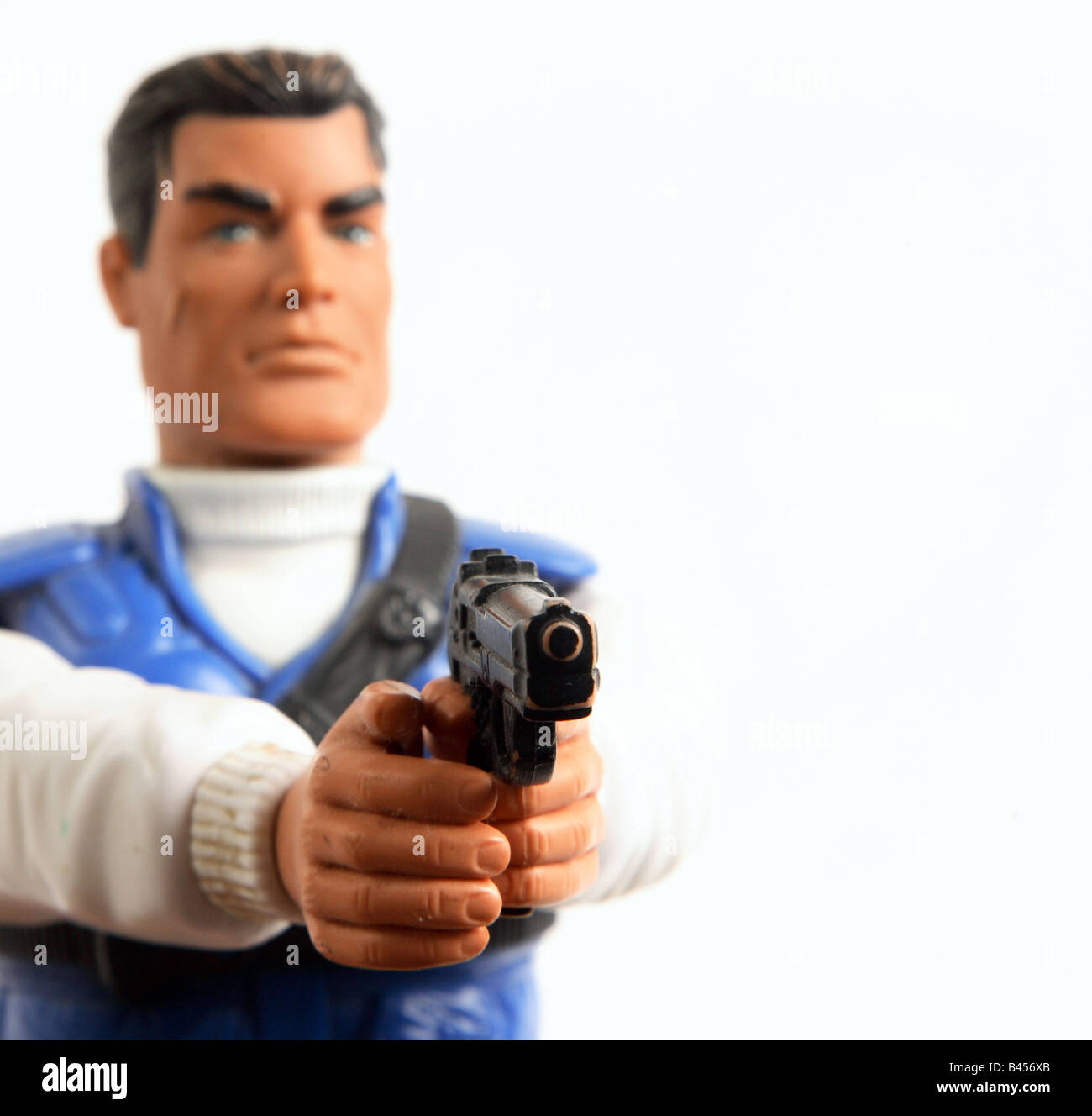 Cut out shot of action man figure holding a pistol gun Stock Photo Alamy