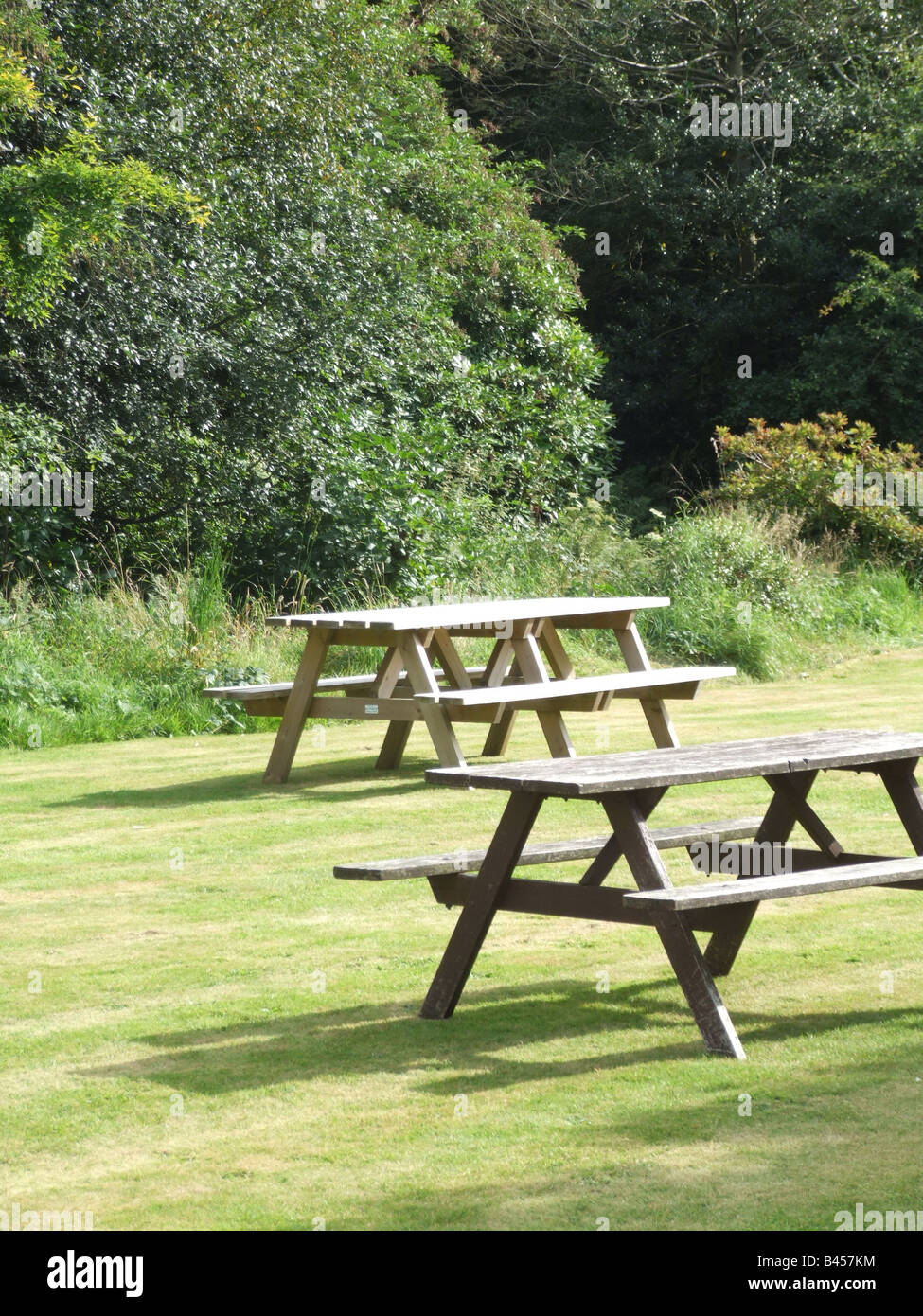 Picnic Tables In Pub Garden In Sun In Countryside Stock Photo