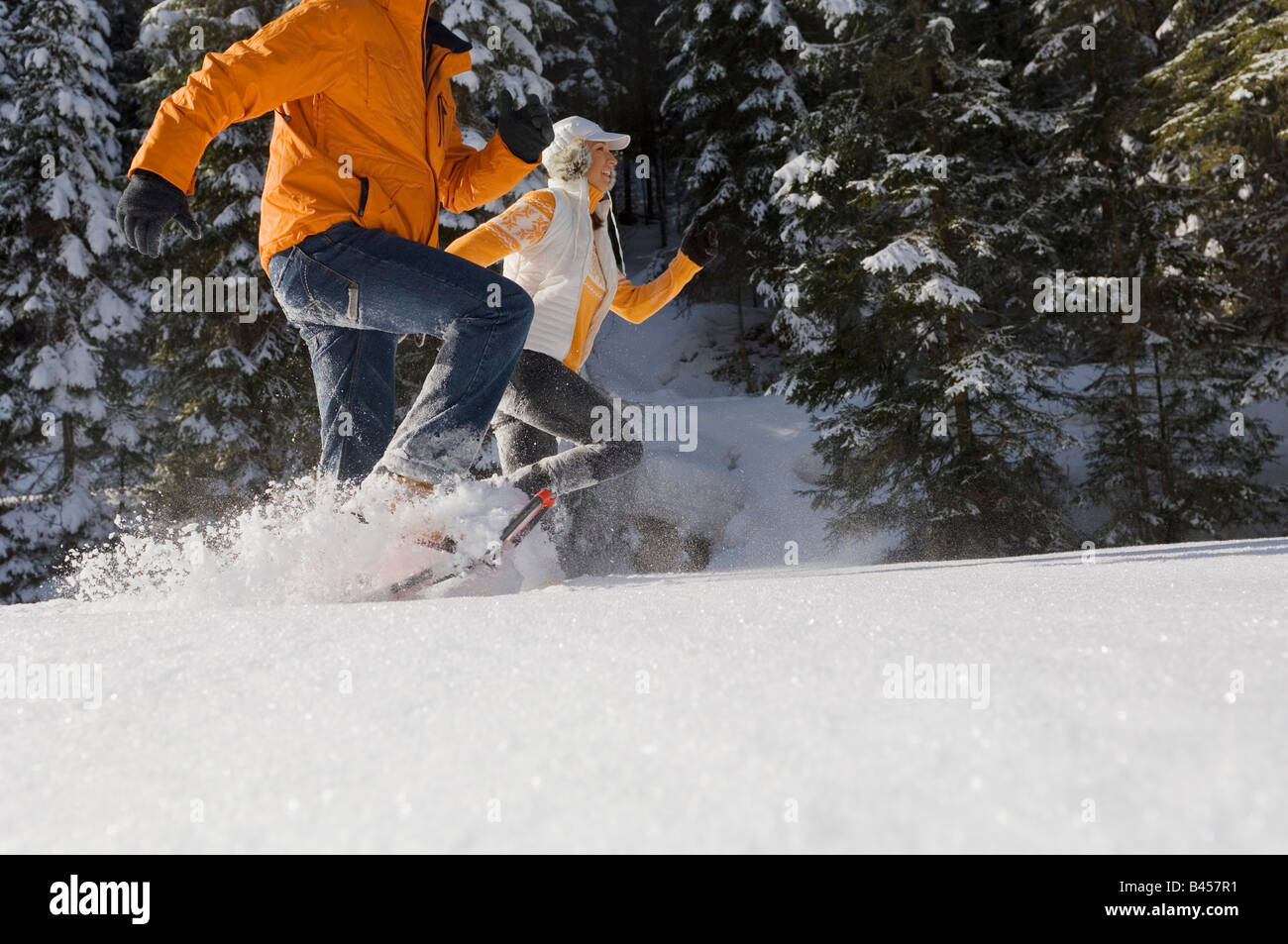Austria, Salzburger Land, Altenmarkt-Zauchensee, Young couple running in snow Stock Photo