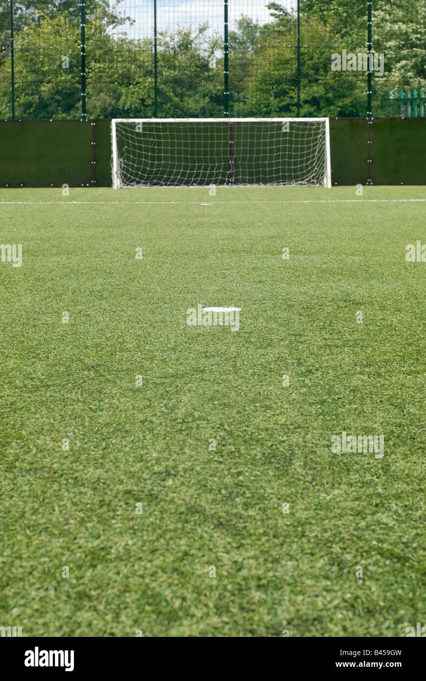 Young footballer in control of the ball on a Astra Turf pitch Stock Photo -  Alamy