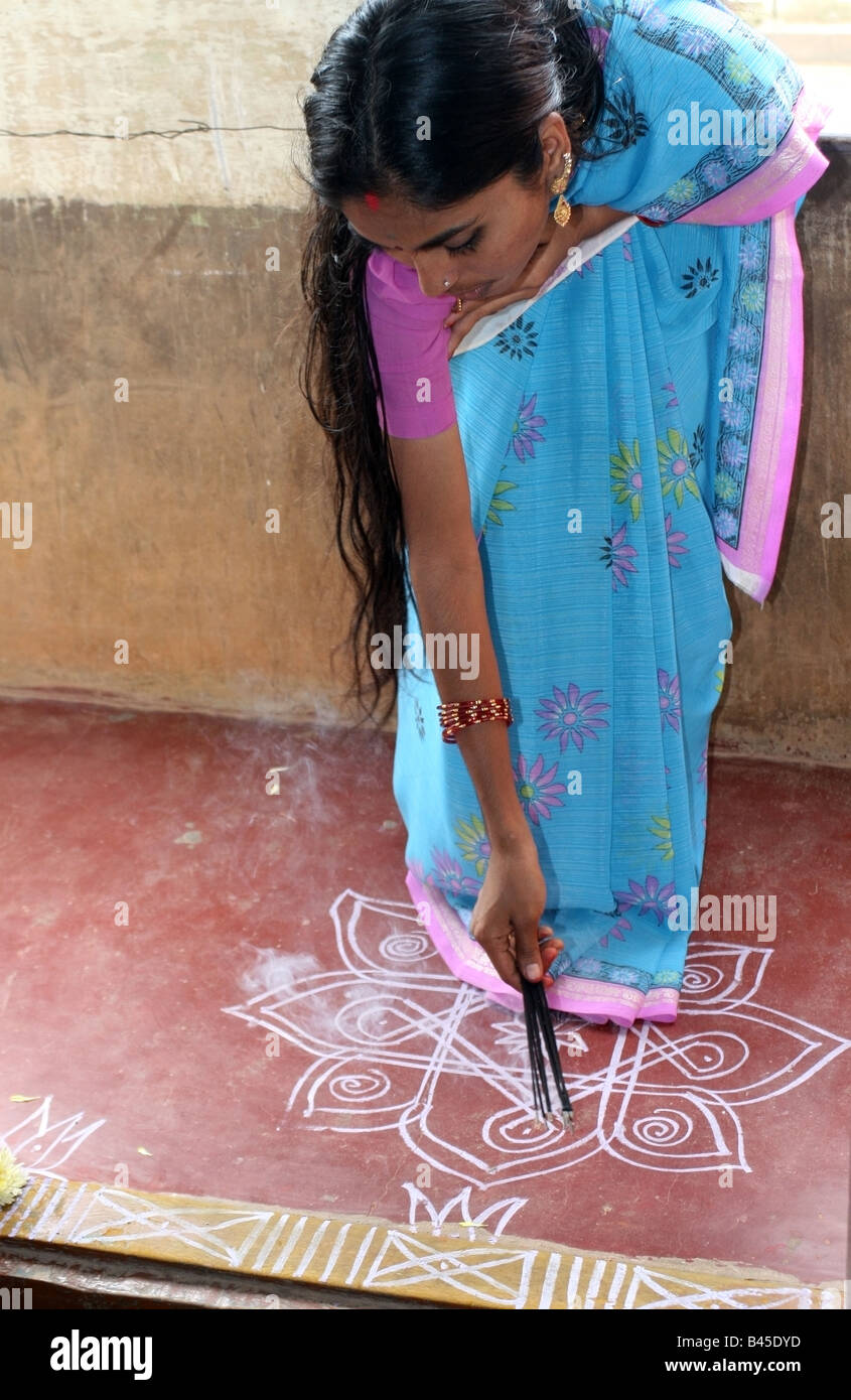 Indian lady blessing her home with incense during Vishwakarma Ayudha Puja ceremony , India Stock Photo
