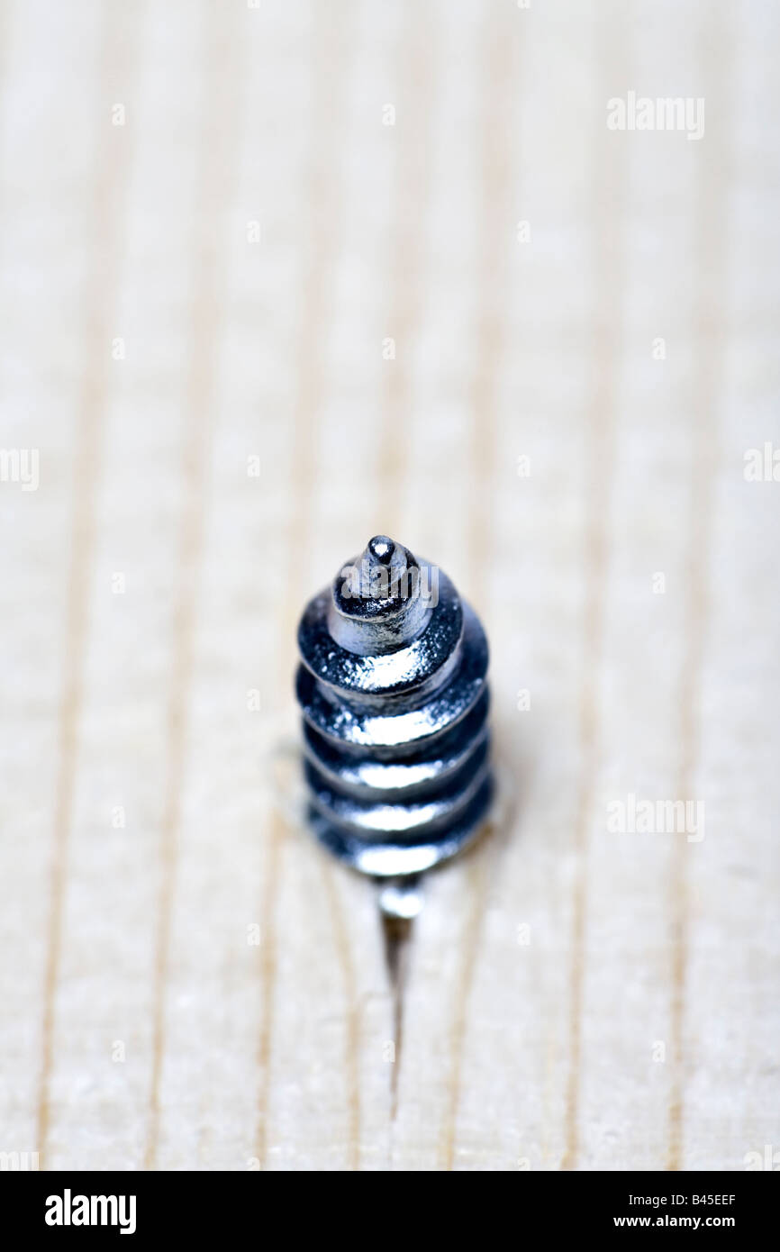 New screw breaking through wood macro Stock Photo Alamy