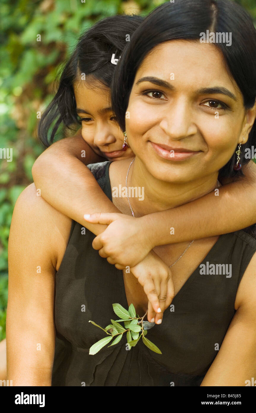 Indian daughter hugging mother Stock Photo
