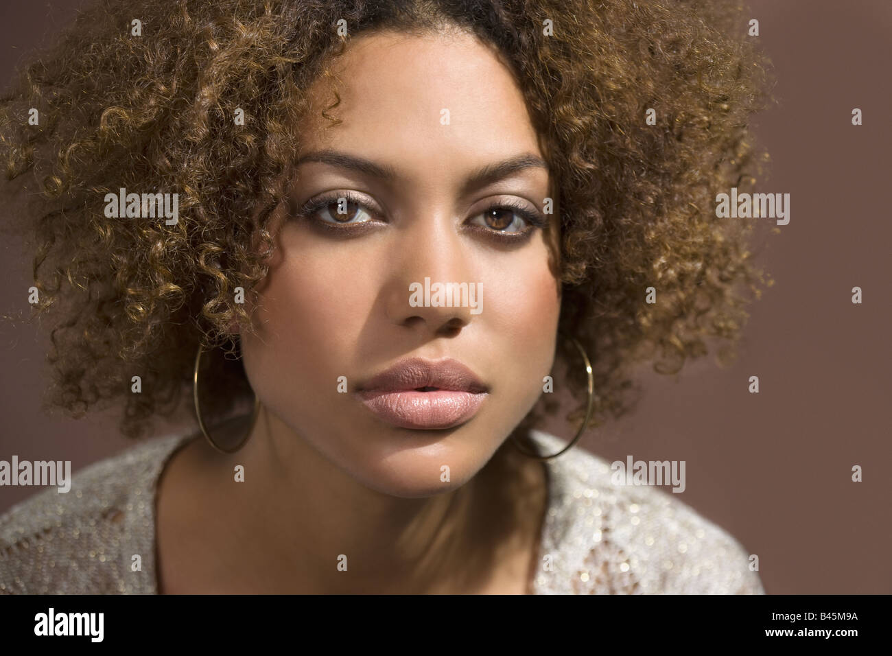 Mixed Race woman with curly hair Stock Photo Alamy