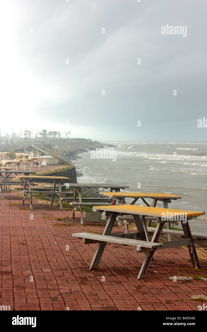 Picnic tables at a deserted beach eating area near Tainan, Taiwan Stock Photo