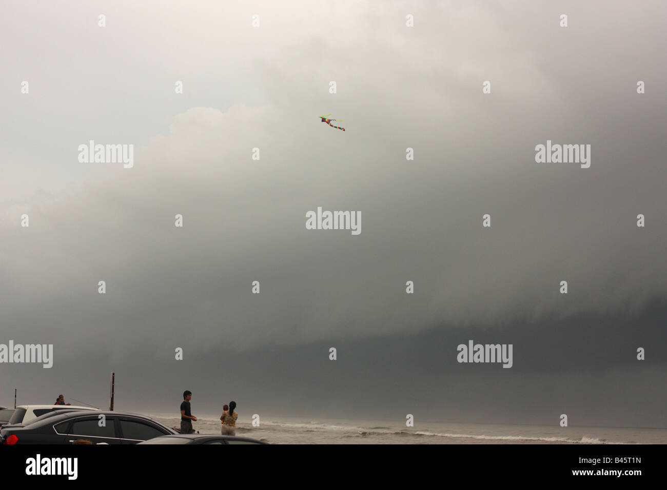 A person flying a kite as a storm front approaches Stock Photo Alamy
