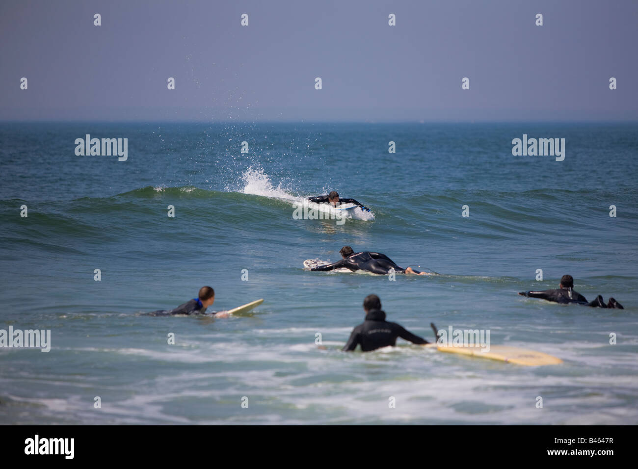 Surfing waves of Far Rockaway Beach on a very hot day of June Far