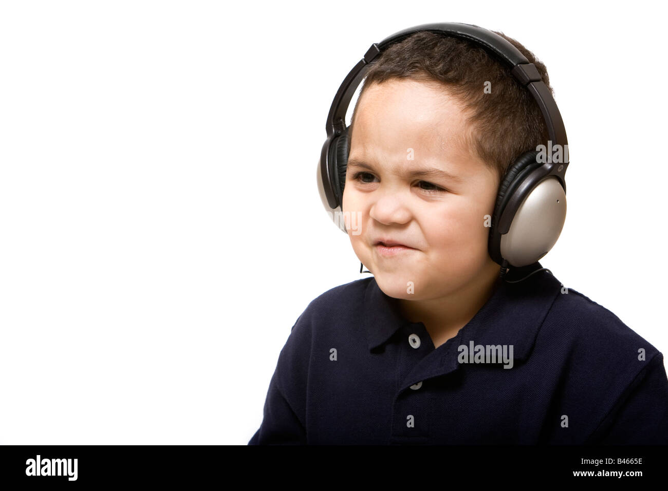 Sad boy with headphones not liking song choice Stock Photo Alamy