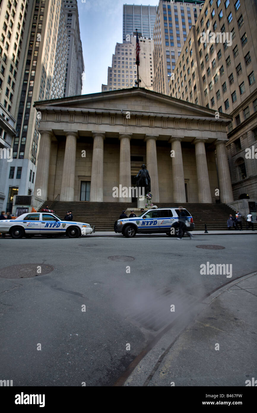 Federal Hall with statue of George Washington.  Steam coming out of the sewer system in foreground  Wall Street, New York City, Stock Photo