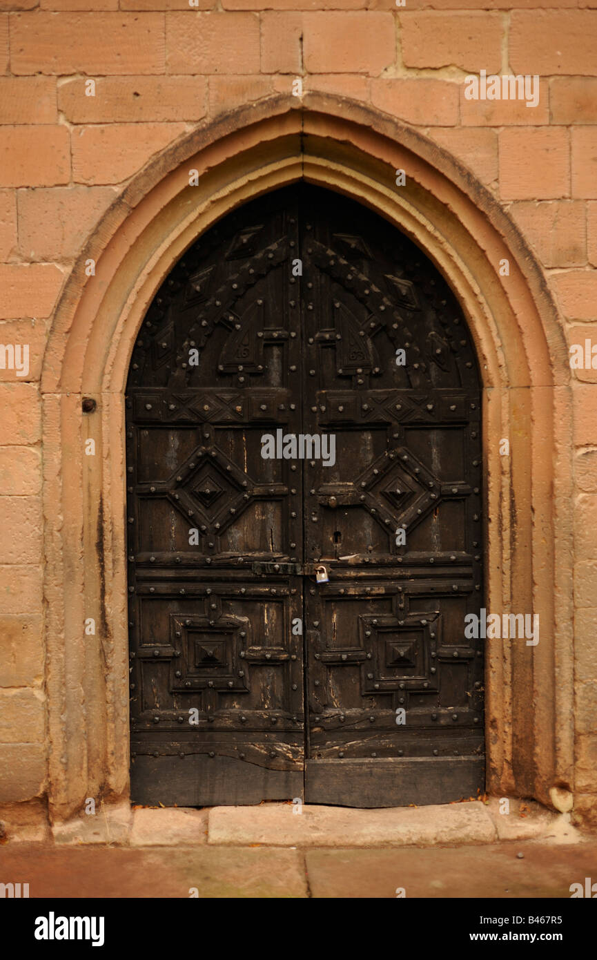 A heavily carved ornate wooden church door Stock Photo