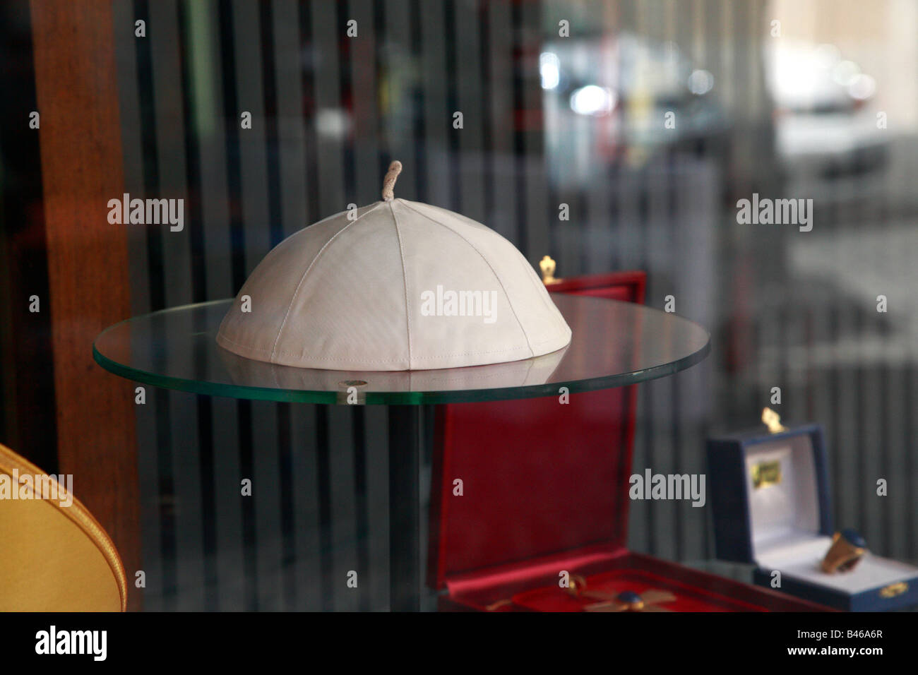 Roman catholic priests skull cap on display in shop window Stock Photo