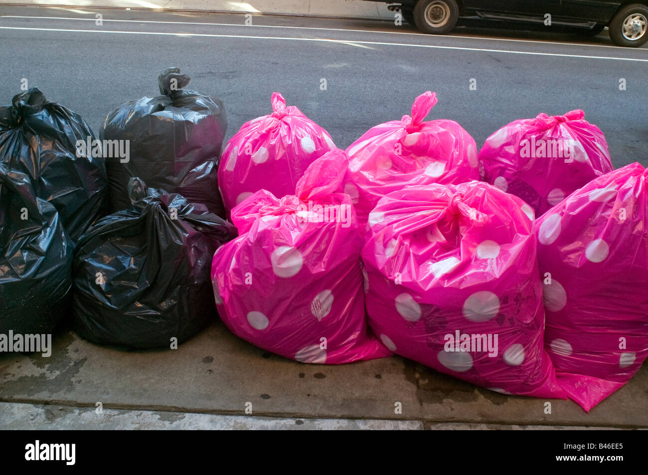 Colorful pink polka dot plastic trash bags are piled on the street awaiting  collection in the West Chelsea gallery district Stock Photo - Alamy