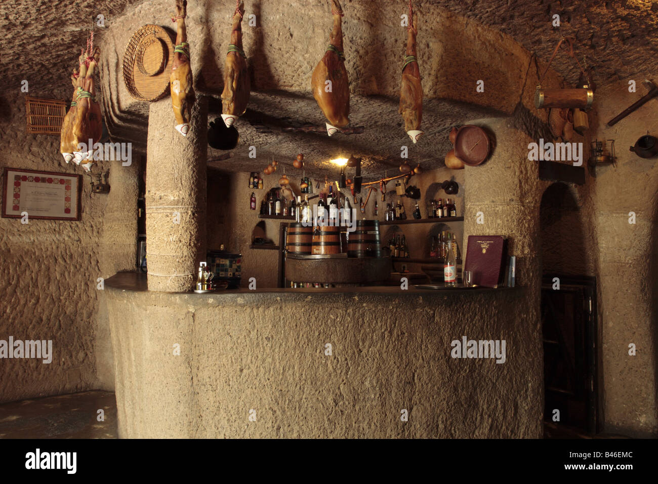 Bar with jamon serrano hanging in the restaurant Tagoror in a cave in the Barranco de Guayadeque in Gran Canaria Canary Islands Spain Stock Photo
