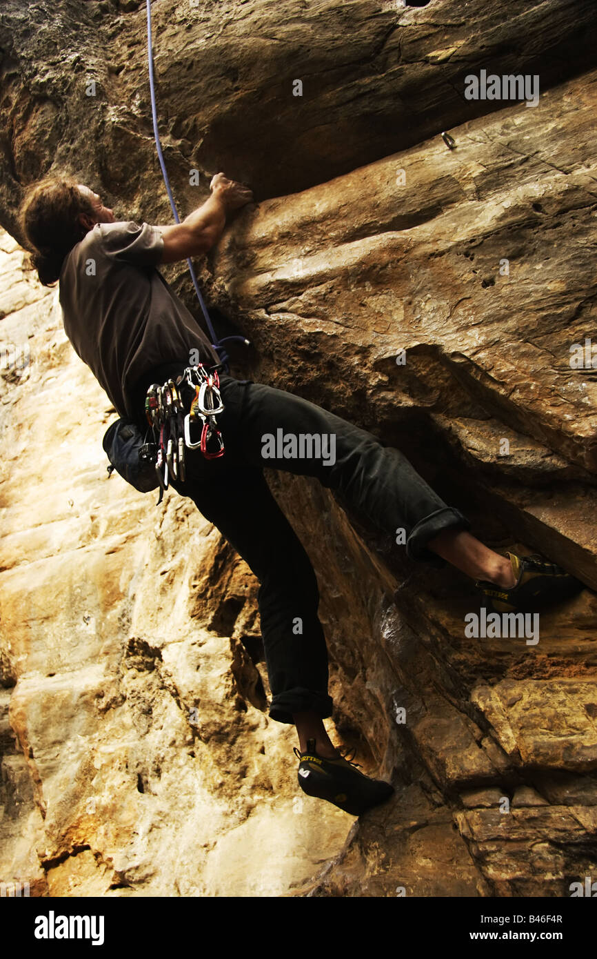 Rock climber hanging from a cliff overhang in Nepal Stock Photo