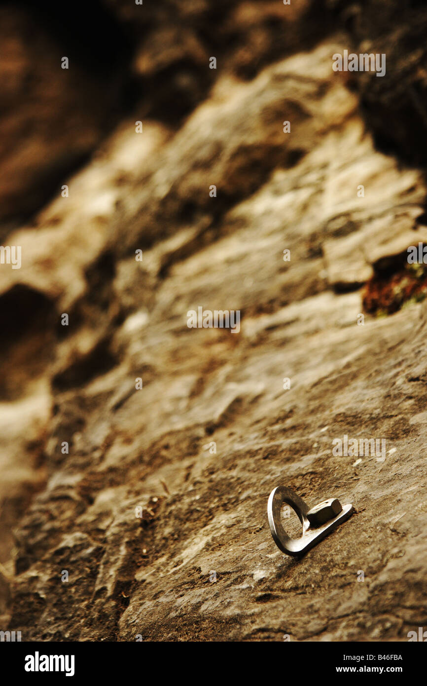 A piton or climbing peg hammered into a rock wall Stock Photo Alamy