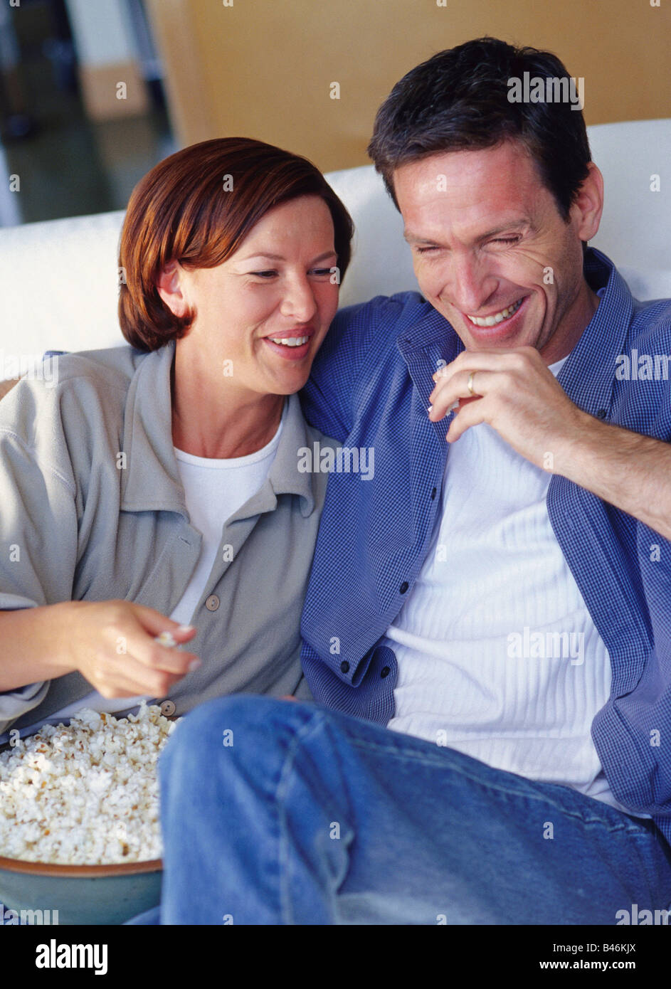 Couple Sitting On Couch Stock Photo Alamy