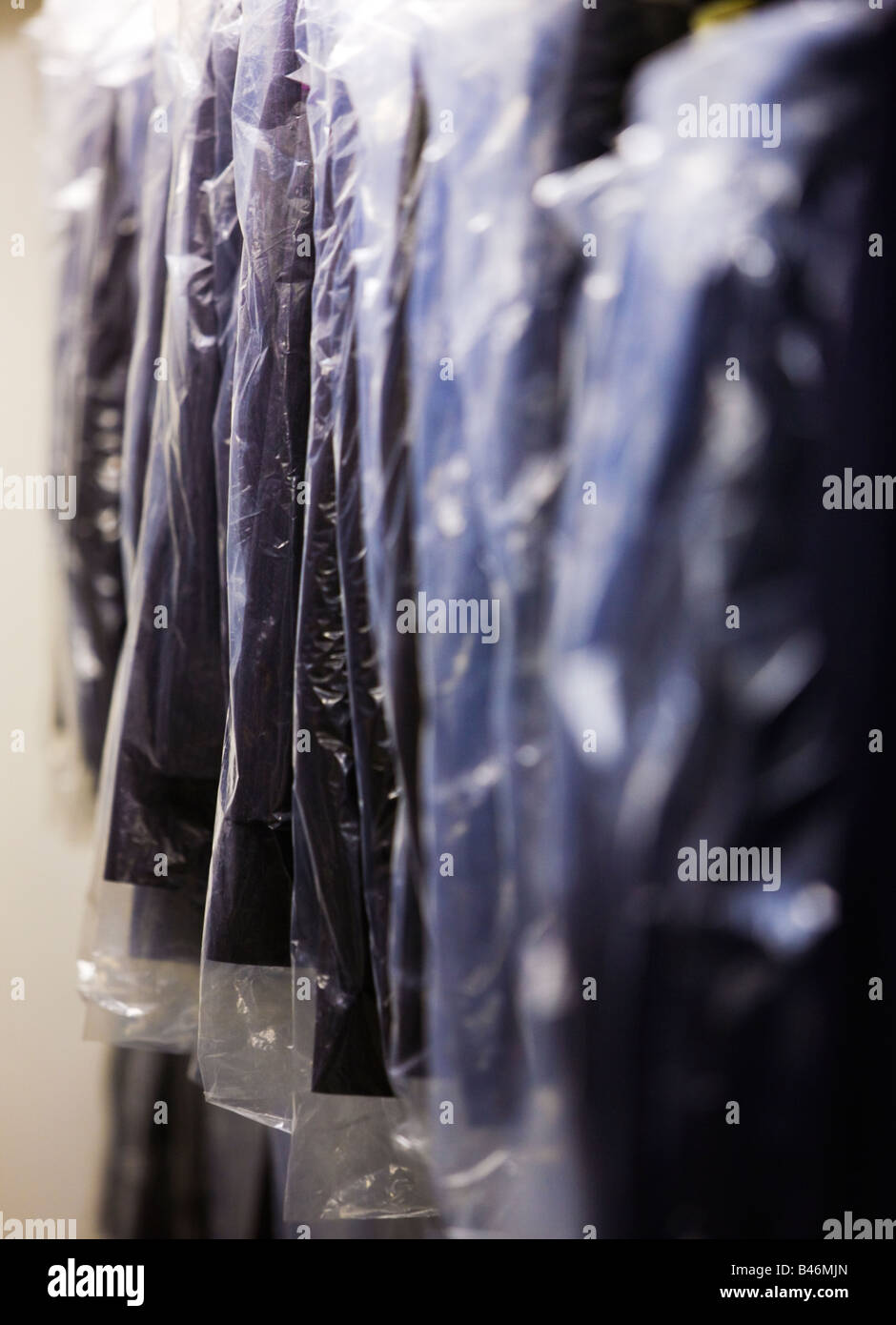 Dry cleaners, cleaning shop with cleaned suits on a rack Stock Photo