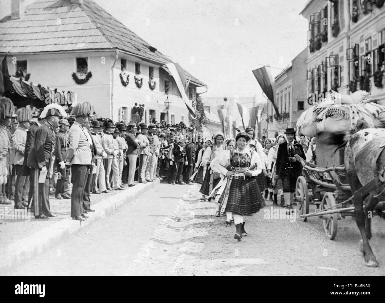 military, Austria-Hungary, Austrian soldiers watching pageant, early 20th century, Austria, Hungary, uniform, uniforms, costume, costumes, cart, crowd, officers, historic, historical, people, 1900s, 1910s, Stock Photo