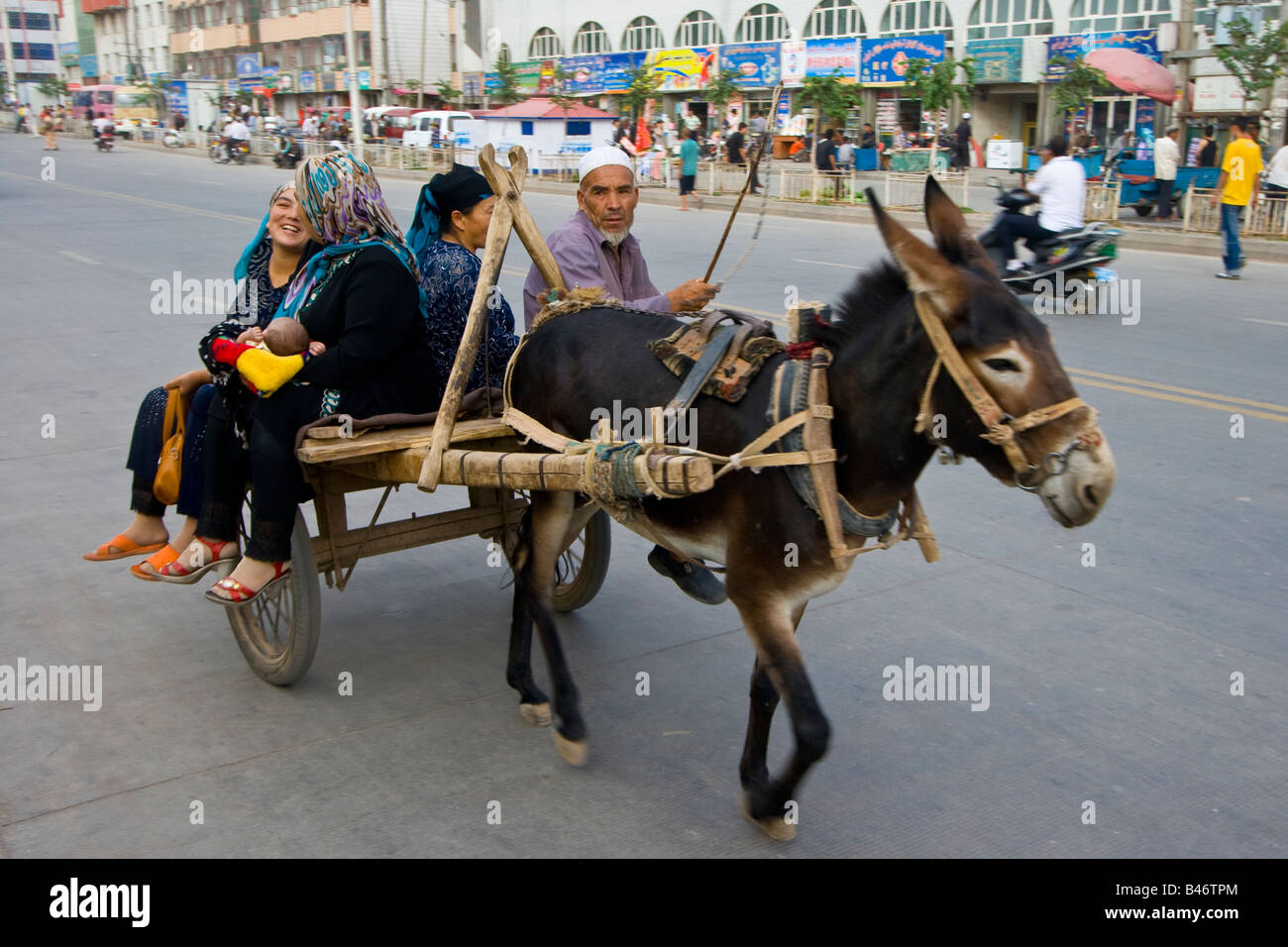Women Riding a Donkey Cart Outside the Sunday Market in Kashgar in