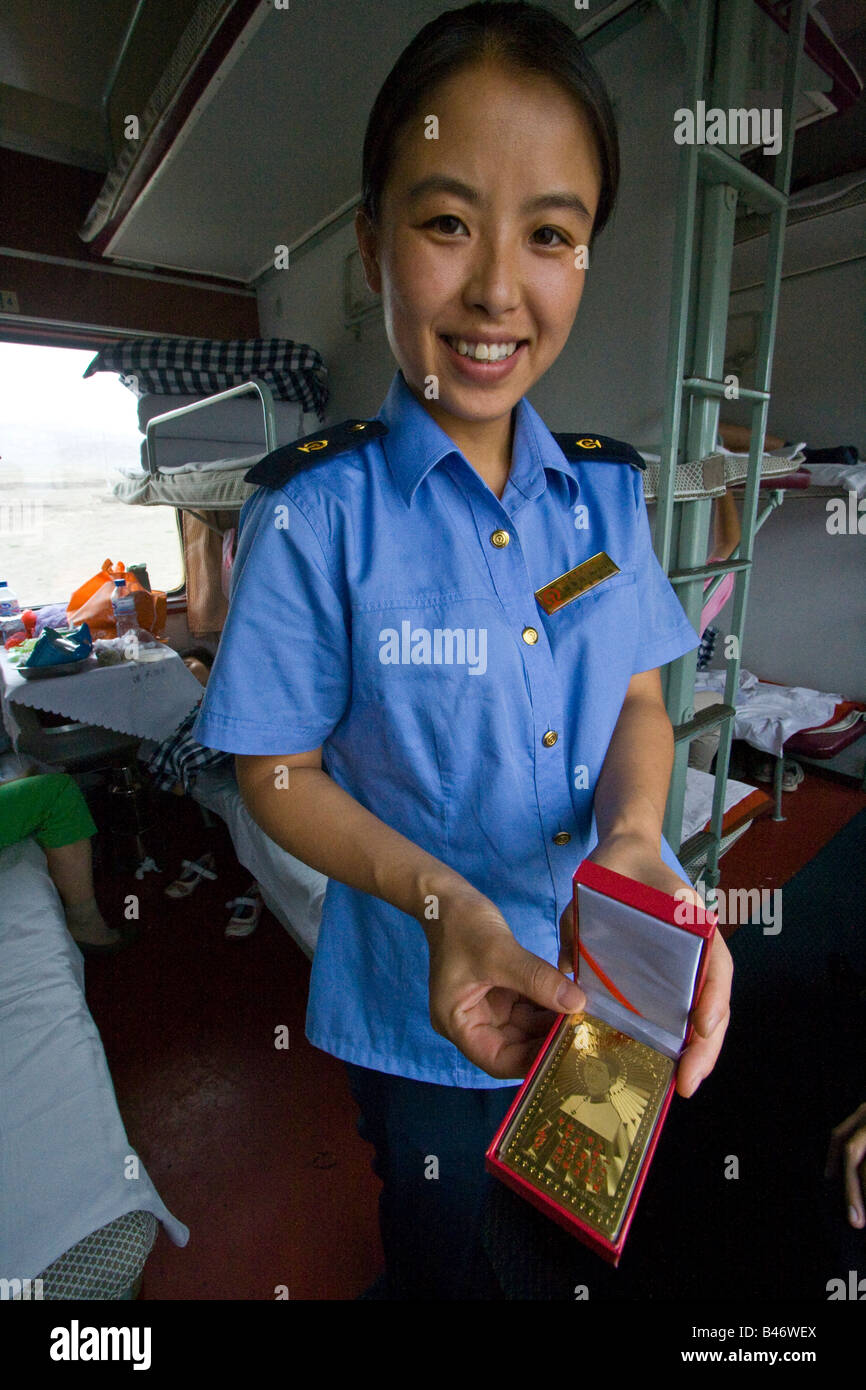 Train Attendant Selling Mao Souvenirs on a Chinese Sleeper Train Stock Photo