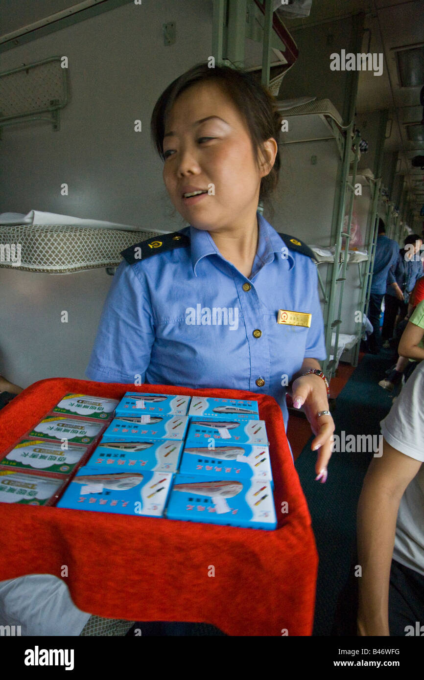 Train Attendant Selling Random Items on a Chinese Sleeper Train Stock Photo