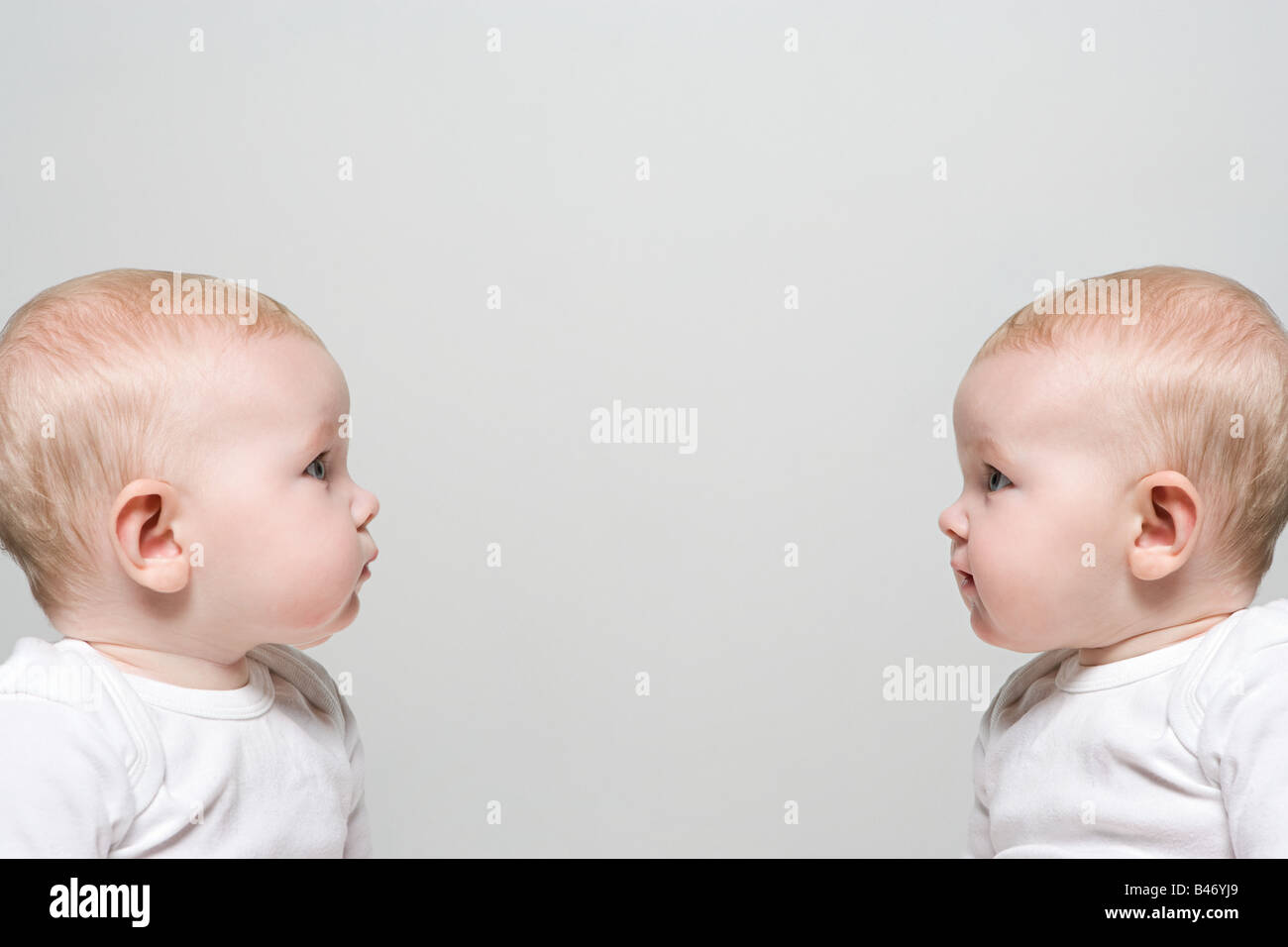 Babies face to face Stock Photo