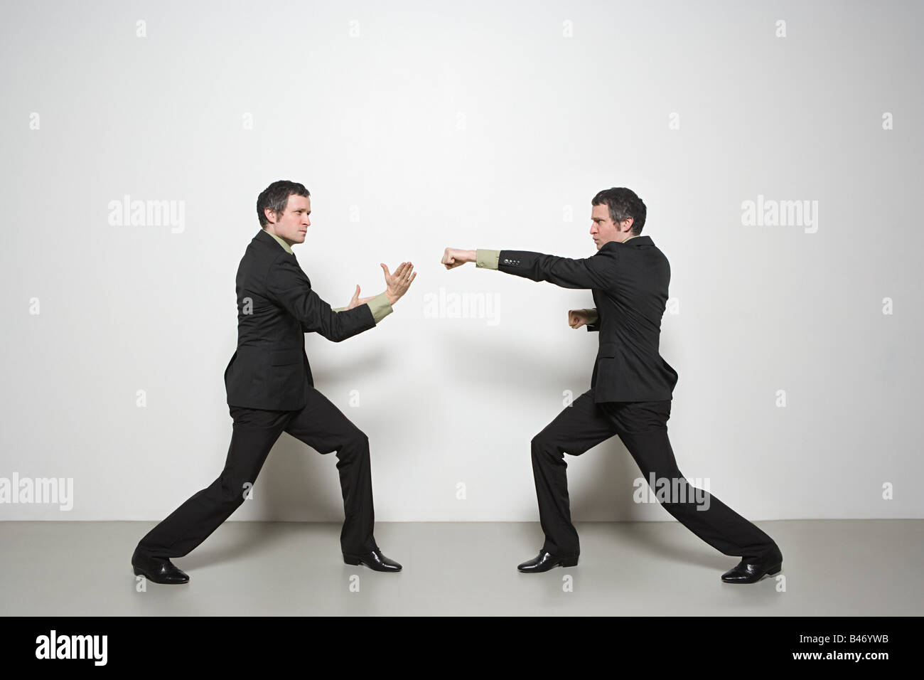 Businessman fighting himself Stock Photo