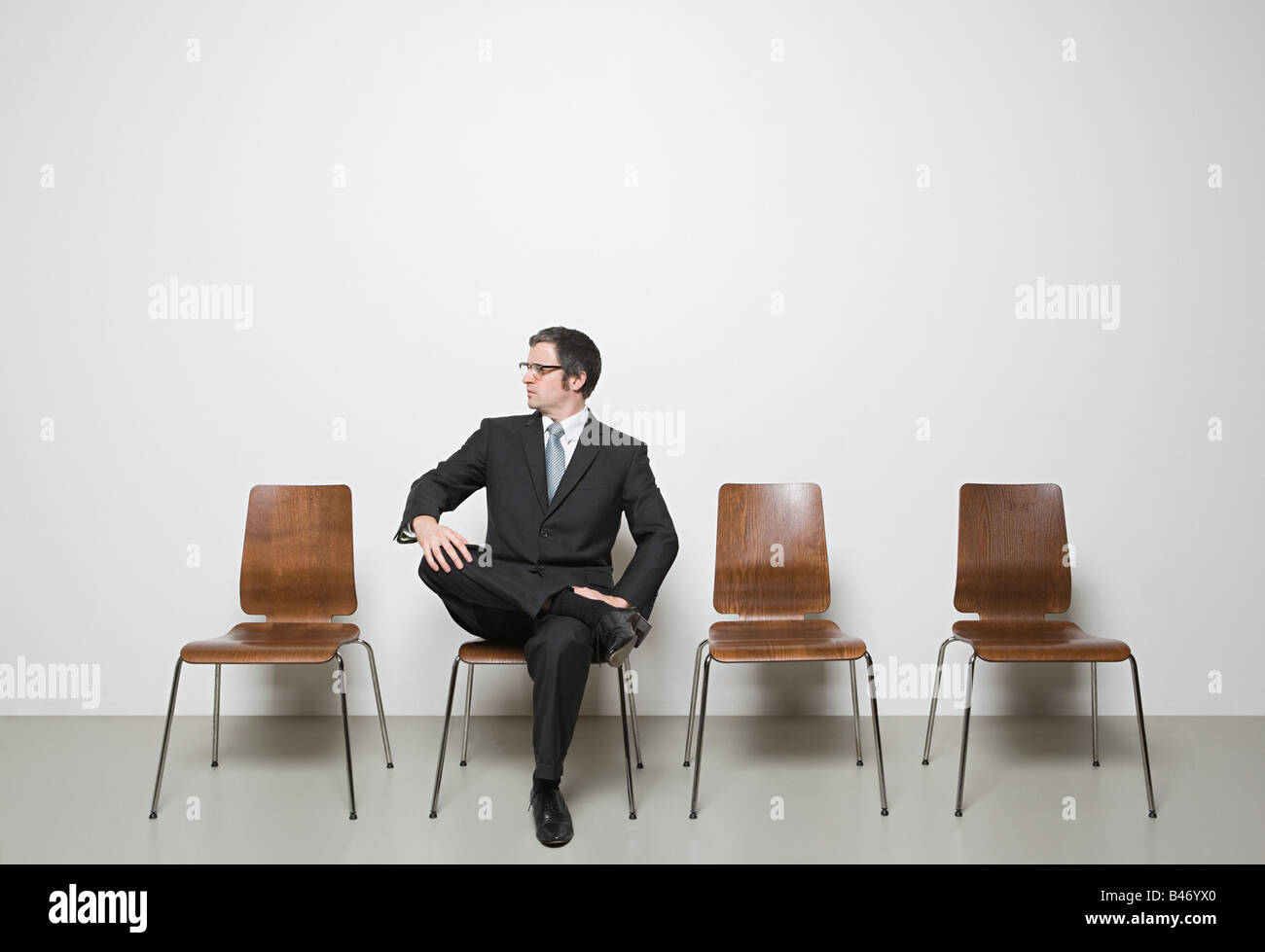 Businessman sitting in chair Stock Photo