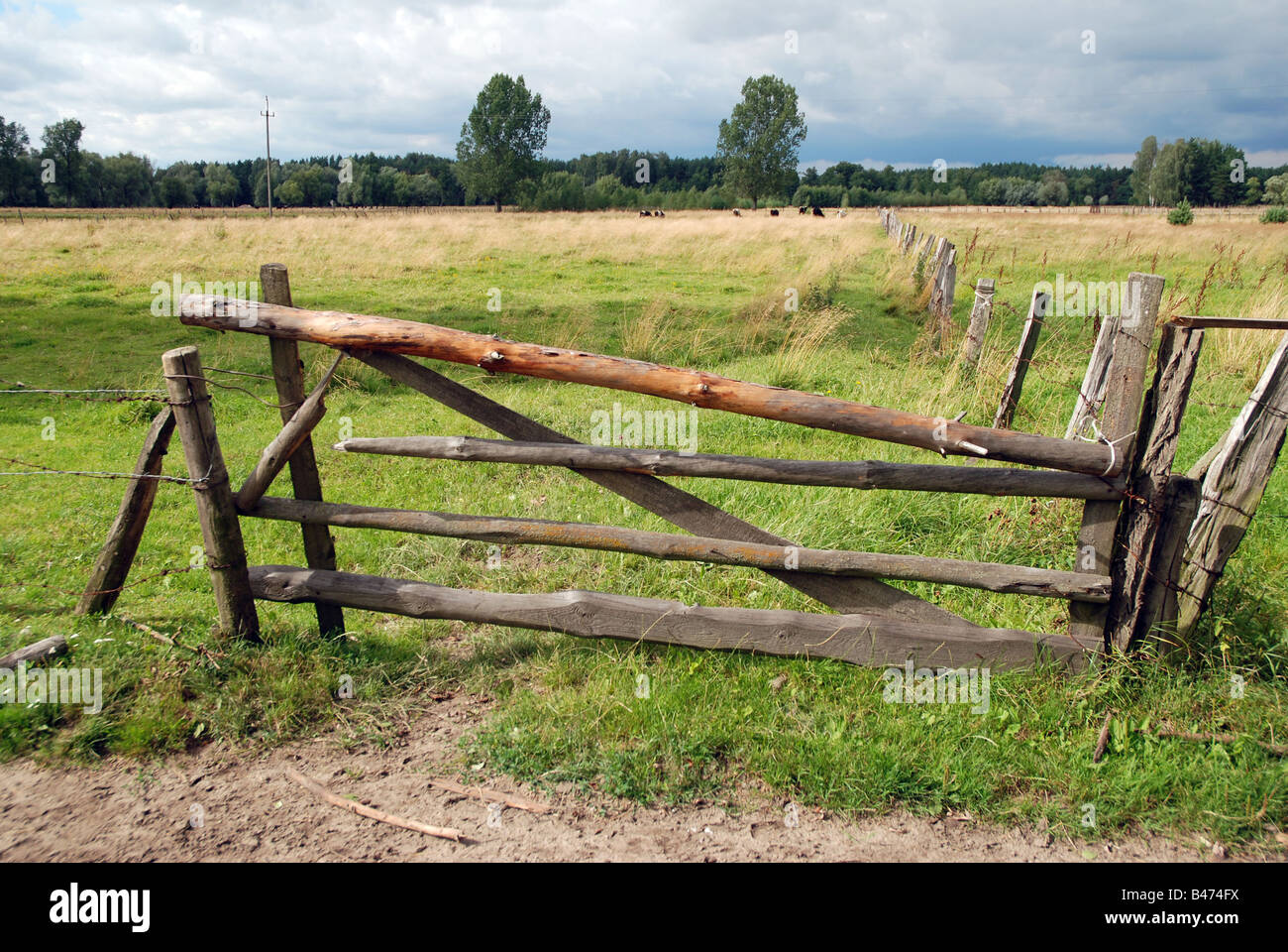 Barbed wire fence and wooden gate on polish countryside Stock Photo Alamy