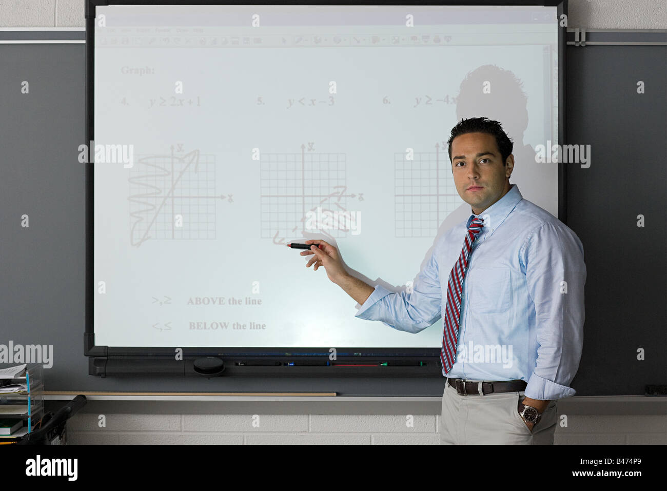 A teacher pointing at a projector screen Stock Photo Alamy