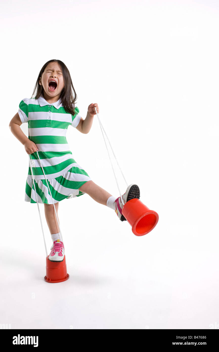A girl using stilts Stock Photo Alamy