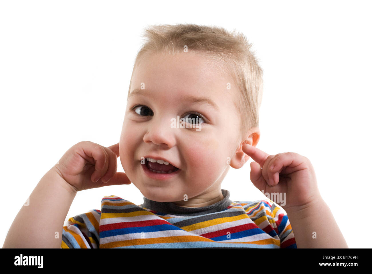 A toddler with his fingers in his ears Stock Photo Alamy