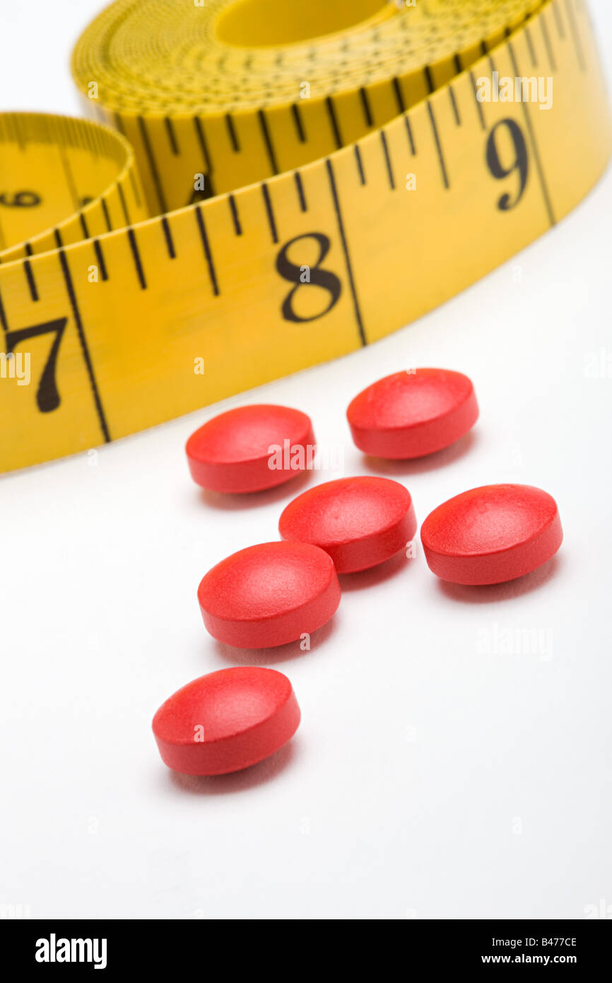 Tape measure and diet pills Stock Photo