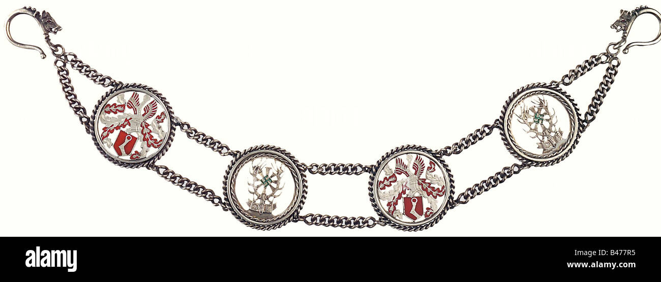 Hermann Göring - a heavy silver watch chain., Silver, rubies, green tourmalines, red enamel. The red enamelled great helmeted Göring family coat of arms alternates with the emblem of the German Hunting Association. The swastikas are of cut green tourmalines, the boars' eyes are rubies. Hallmark "925". Length 38.5 cm. Weight 180 g. On a small decorative tablet with two gold-plated hunting-style pins. Although it does not have the master's mark of Prof. Herbert Zeitner, it is still most probably his work. historic, historical, 1930s, 1930s, 20th century, NS, Nati, Stock Photo