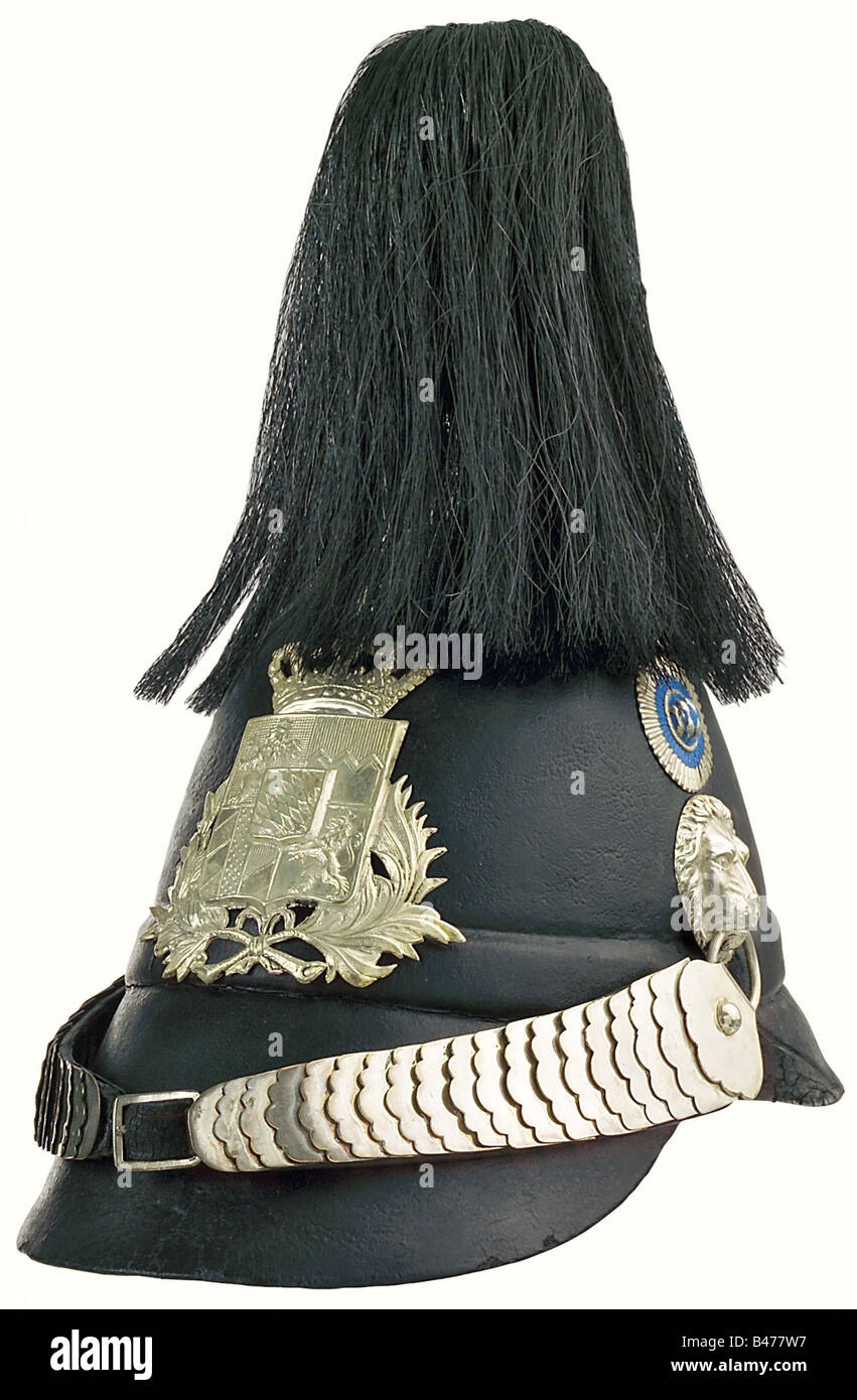 A model 1850 Civil Guard helmet, for enlisted personnel. Black leather skull with silver-coloured mountings, enlisted men's cockade, flat metal chin strap. Leather lining. Black horsehair brush. Wonderful condition. historic, historical, 19th century, Bavaria, Bavarian, German, Germany, Southern Germany, the South of Germany, object, objects, stills, militaria, clipping, cut out, cut-out, cut-outs, helmet, helmets, headpiece, headpieces, utensil, piece of equipment, utensils, protection, headgear, headgears, uniform, uniforms, Stock Photo