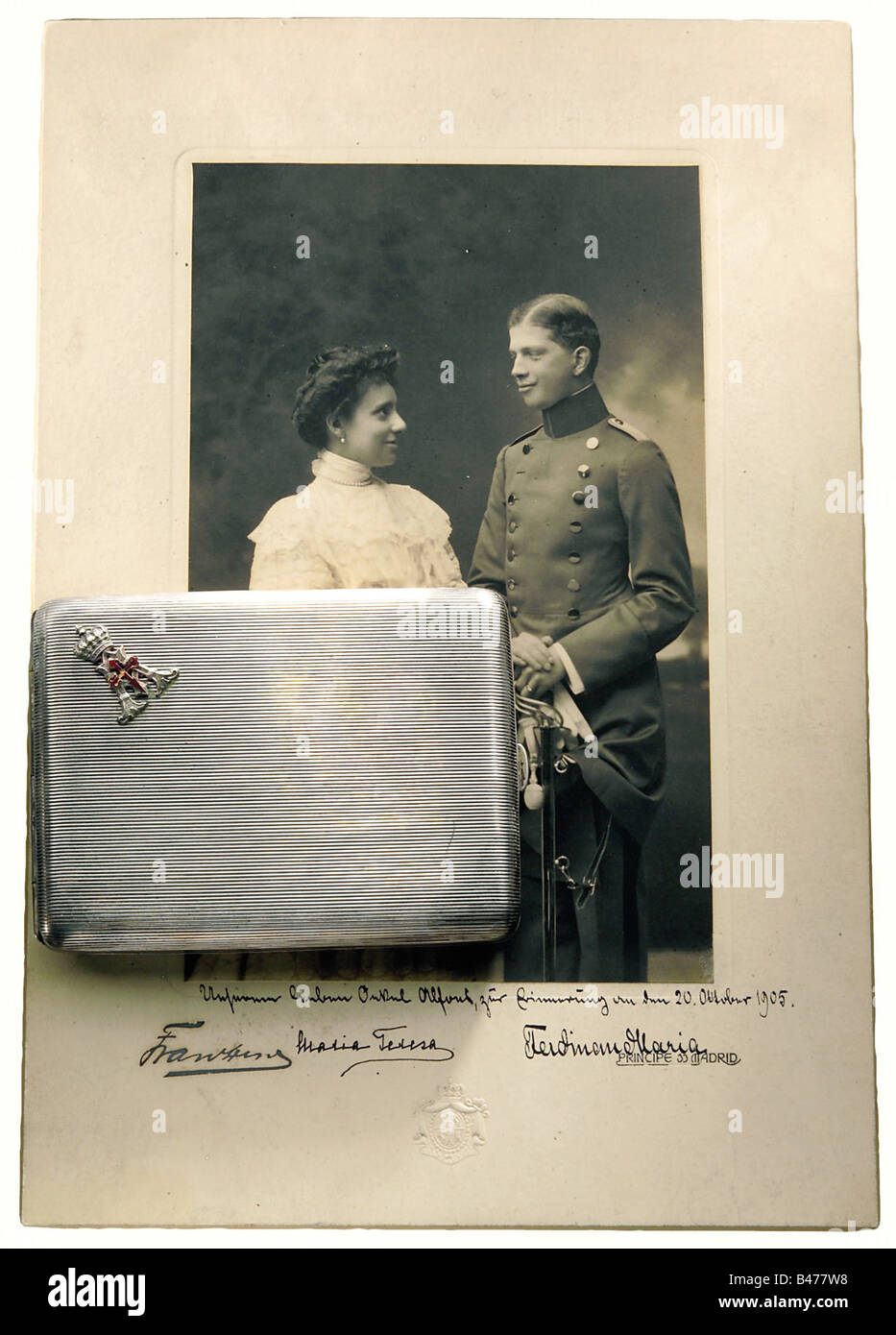 Prince Alfons - a cigarette case, a gift from his nephew Ferdinand Maria on 20 October 1905. Silver. The Prince's crowned monogram "A" on the lid with a red enamelled cross of the Order of St. Jacob. The interior is gold-plated and engraved "dem lieben Onkel Alfons am 20. Oktober 1905 - Ferdinand Maria" (to Dear Uncle Alfons on 20 October 1905 - Ferdinand Maria). Hallmark "900" and master's mark "LW". Closed dimensions 12 x 9 cm. Weight 182 g. There is also a large presentation photograph of Prince Ferdinand Maria and his wife, Maria Theresa with a handwritten , Stock Photo