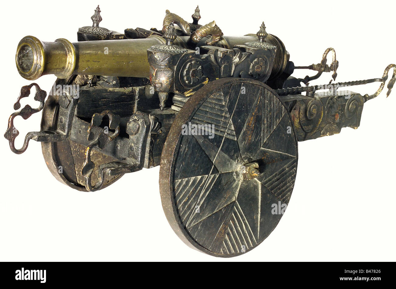 A model cannon, China, circa 1900. A heavy bronze barrel with a reinforced muzzle and breech. Touchhole on top with two dolphin-shaped handles. Barrel length 73 cm. Darkly finished, carved wooden carriage with iron furniture, full wooden wheels with star-shaped decoration, and iron loading tools. Total length 112 cm. historic, historical, 19th century, Far East, Far Eastern, weapon, arms, weapons, arms, military, militaria, clipping, cut out, cut-out, cut-outs, object, objects, stills, Stock Photo