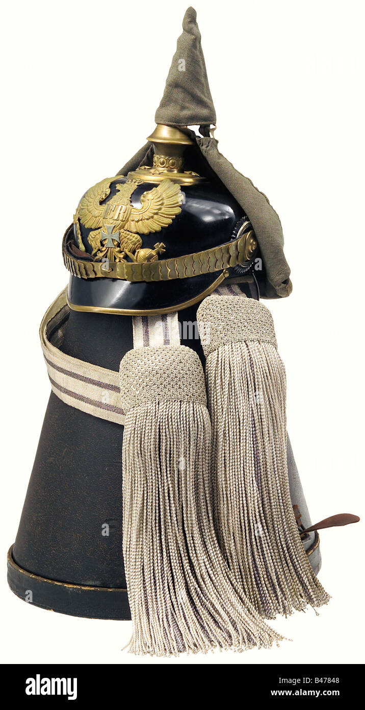 A model 91 helmet for reserve officers, of the line infantry. Black lacquered fiber bowl with gilded trims. Plate with the silver reserve cross. Flat metal chinscales on rosettes, and both cockades. Beige ribbed silk lining and brown sweatband with marks of wear. Size 55. Complete with a field grey cover and in the protective case (straps torn). There is also the full dress sash of silver weaving interwoven with black (darkened). historic, historical, 19th century, Prussian, Prussia, German, Germany, militaria, military, object, objects, stills, clipping, clipp, Stock Photo