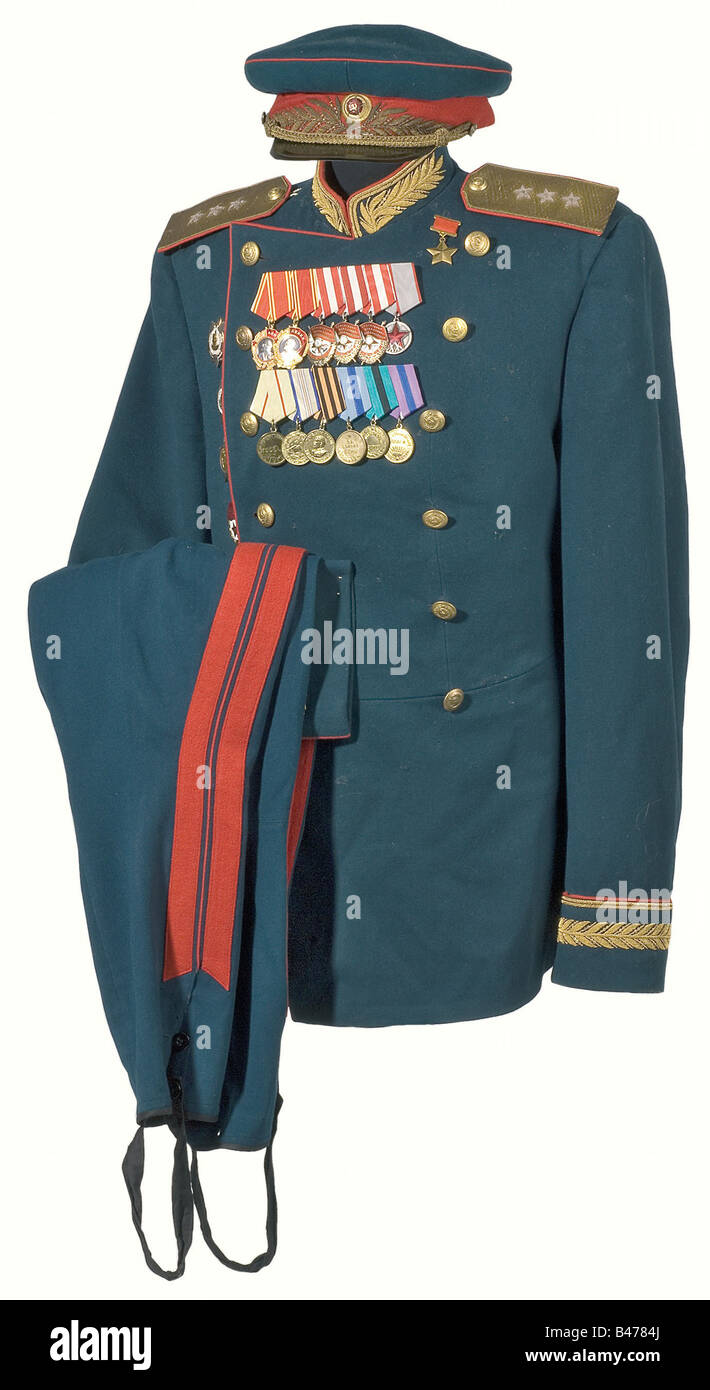 A dress uniform of 1945 pattern for a Generaloberst (General), of Land Forces. Blue-green service cap with red lace and piping with an enamelled star between gold embroidered leaves, golden cap cord (restored later, circa 1960, visor, sweatband, and lining replaced). Green, double-breasted tunic with red piping, gold embroidered collar and cuffs. Sleeved golden shoulder boards with three silver rank stars, golden buttons bearing coats of arms, (various). Restored and mended in several spots. Green breeches from circa 1960 with broad, red leg stripes. There are , Stock Photo