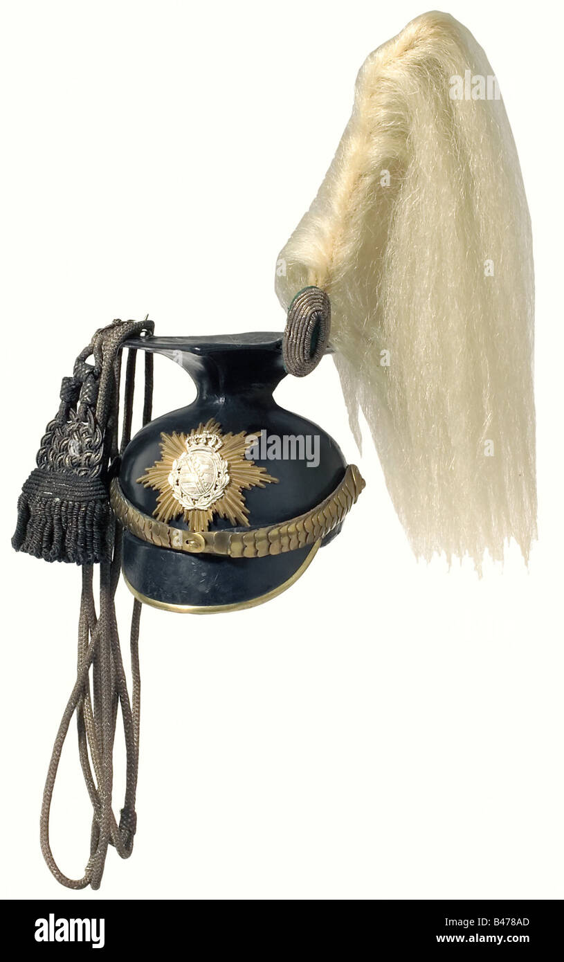 Saxony: A czapka for Uhlan officers., The leather skull is made of four segments. The gilt plate bearing a silvered coat of arms was substituted during active service. Cambered chinscales (the imperial cockade missing), a falling horsehair plume and an officer's field badge. Cap lines are attached, these are considerably darkened, the interlaces bleached by age. Dark grey ribbed silk liner, black sweatband with slight traces of wear. A maker's label is glued to the inside. Size 54. historic, historical, 19th century, uniform, uniforms, headpiece, headpieces, pi, Stock Photo