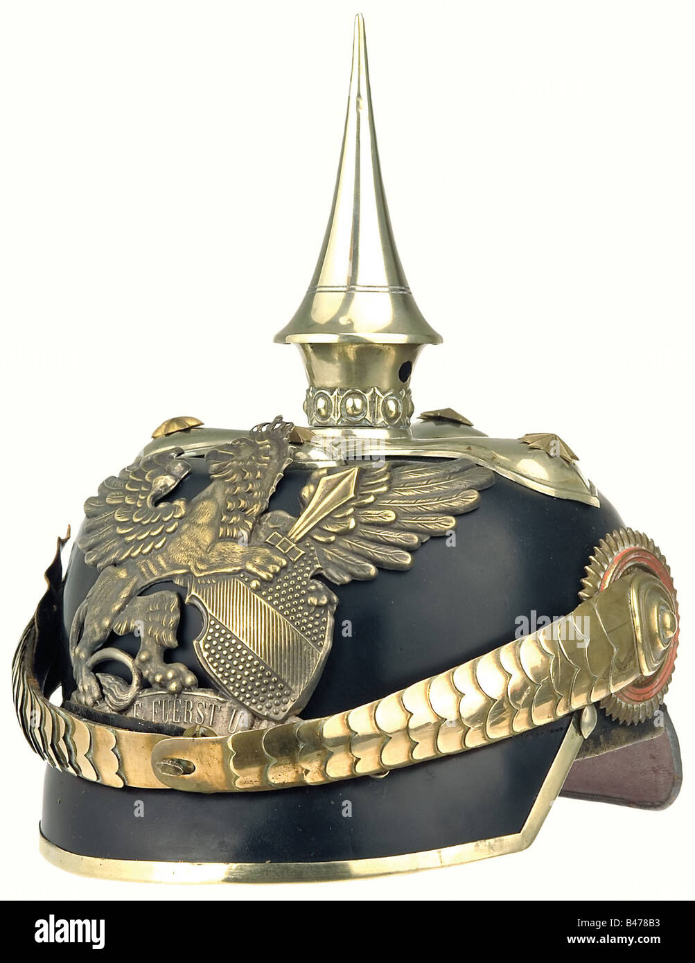 Baden: A uniform of a captain (Rittmeister), of the 1st Baden Leib Dragoon Regiment No. 20. An officers' pattern helmet, the lacquer finish is well preserved, the crown of the skull somewhat sunken. The helmet has mountings of German silver, gold chinscales, officers' style cockades, and a ribbed silk liner. Comes complete with carrying case. A tunic with epaulettes, adorned with cast metal crowns. The tunic itself has some tiny, insignificant mothbites, but the colour of the cloth is pristine. Parade sash as for non-Prussian troops, with a red central stripe. , Stock Photo