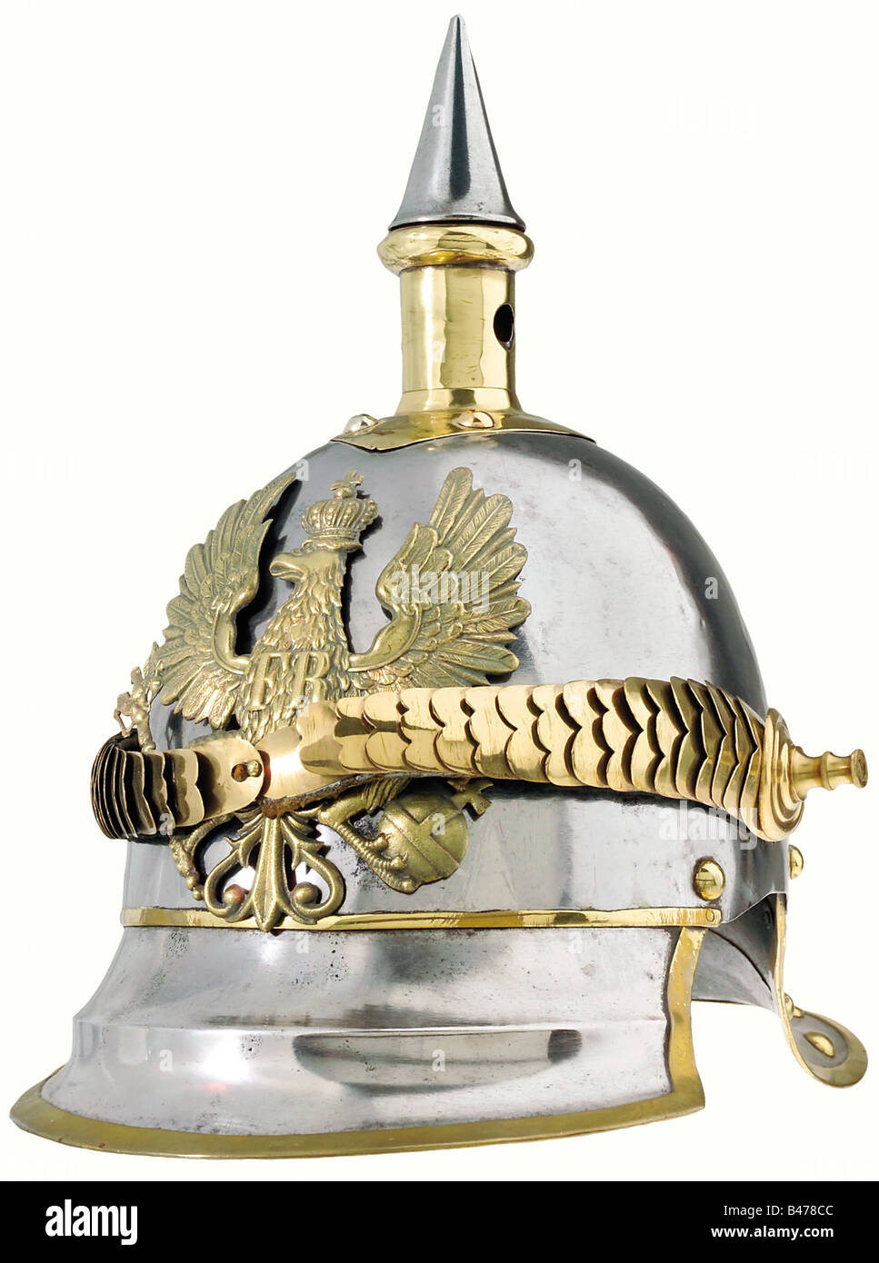 Prussia: A helmet for troopers, of cuirassiers of the line, 1853 pattern. Brass-rimmed steel skull, with slight rust scarring. Some former attachment holes have been filled in by soldering. Brass fittings. The plate is of an older pattern. The cambered chinscales (not original) are attached by long replacement stud bolts. Multiple stamp marks are visible below the left rosette. The leather liner of the visor has some flaws, and the lining of the skull is missing. Approx. size 56. historic, historical, 19th century, object, objects, stills, clipping, clippings, , Stock Photo