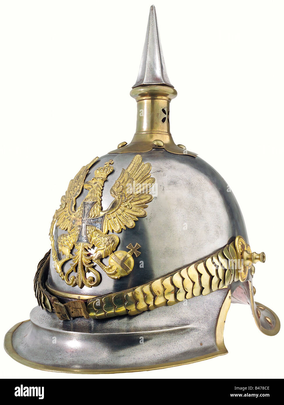 Prussia: A helmet for reserve officers, of cuirassiers, 1843 pattern. Brass-rimmed steel bowl with brass fittings. Gilt plate, slightly polish worn, with a superimposed reserve cross (with one of its arms missing). The attachment screws are old, but not original. Cambered chinscales, attached by long replacement stud bolts. Of the trefoil rosettes, one is original, the other a modern replacement. A leather officer's cockade on the right. The underside of the visor has a recent lacquer finish. The lining is of red leather, worn with age on the underside of the n, Stock Photo