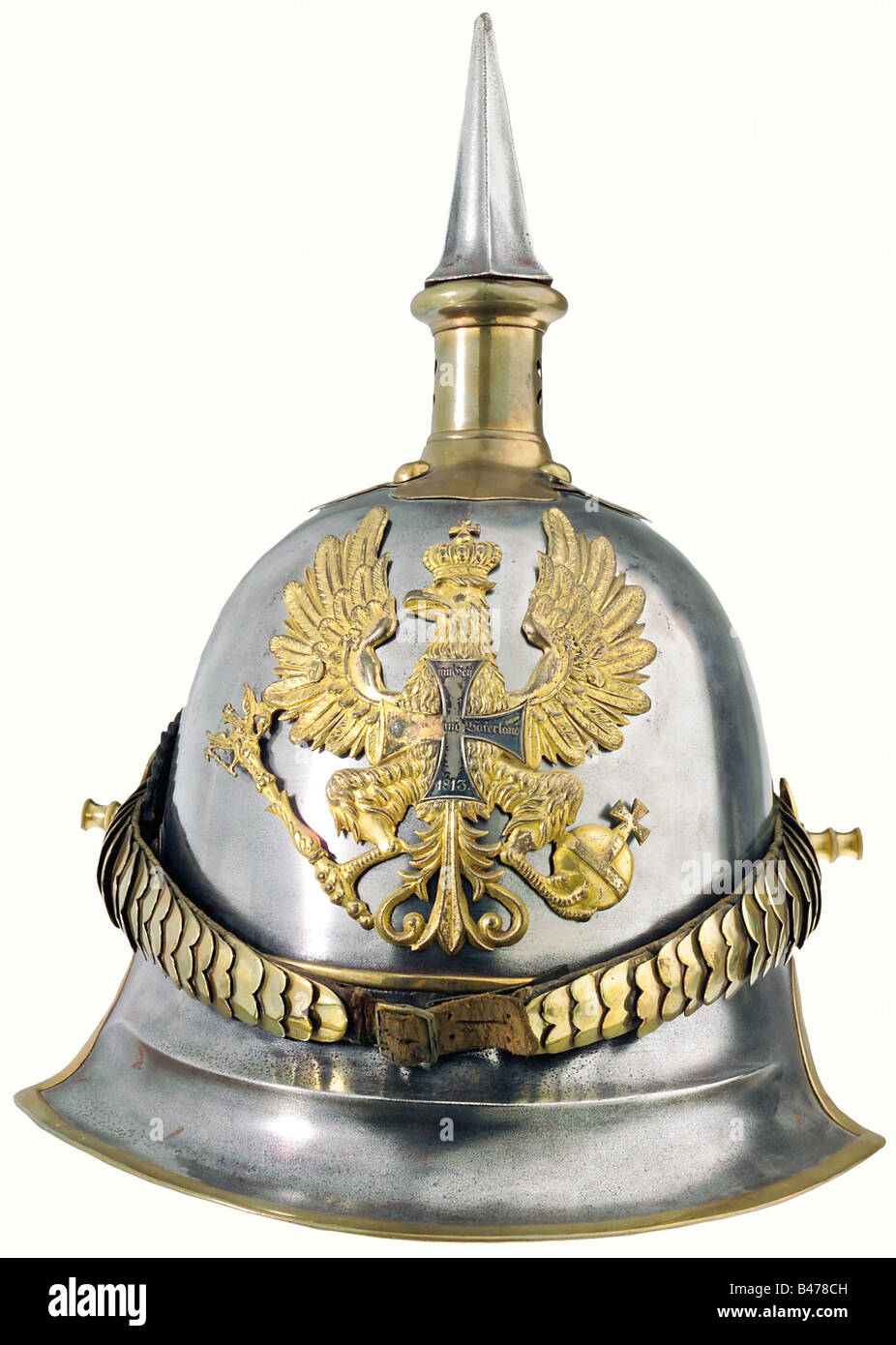 Prussia: A helmet for reserve officers, of cuirassiers, 1843 pattern. Brass-rimmed steel bowl with brass fittings. Gilt plate, slightly polish worn, with a superimposed reserve cross (with one of its arms missing). The attachment screws are old, but not original. Cambered chinscales, attached by long replacement stud bolts. Of the trefoil rosettes, one is original, the other a modern replacement. A leather officer's cockade on the right. The underside of the visor has a recent lacquer finish. The lining is of red leather, worn with age on the underside of the n, Stock Photo