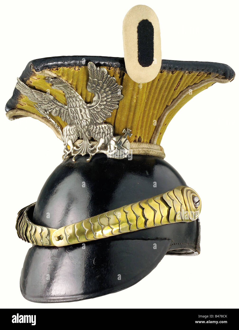 Prussia: A czapka of 1844 pattern for troopers, of the 2nd Brandenburg Uhlan Regiment No. 1. The skull is made of leather, the neck consists of a yellow sleeve over a frame of Spanish cane (with some defects), the piping is made of white cord. A silver eagle badge is mounted on the neck. Cambered chinscales are secured to a black/red/gold cockade. Black leather liner showing signs of wear and ageing. Size 54. historic, historical, 19th century, helmet, helmets, headpiece, headpieces, object, objects, stills, clipping, clippings, cut out, cut-out, cut-outs, Stock Photo