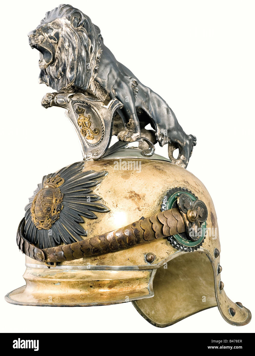 King Friedrich August III, (1865 - 1932). A helmet for an Officer of the Royal Saxon Horse Guard Regiment (1st Heavy Regiment). Gold electroplated tombac helmet skull in a special light version. Silver ceremonial crest in the shape of a lion on a nickel-plated base. Silver-plated star emblem bearing a gold plated coat of arms. Metal chinscales with remnants of gilding on clover leaf shaped rosettes. Officer's cockade. The brim and neck protector are lined with écru coloured velvet. Ribbed silk lining with a somewhat faded monogram, 'F.A.' beneath a crown. Light, Stock Photo