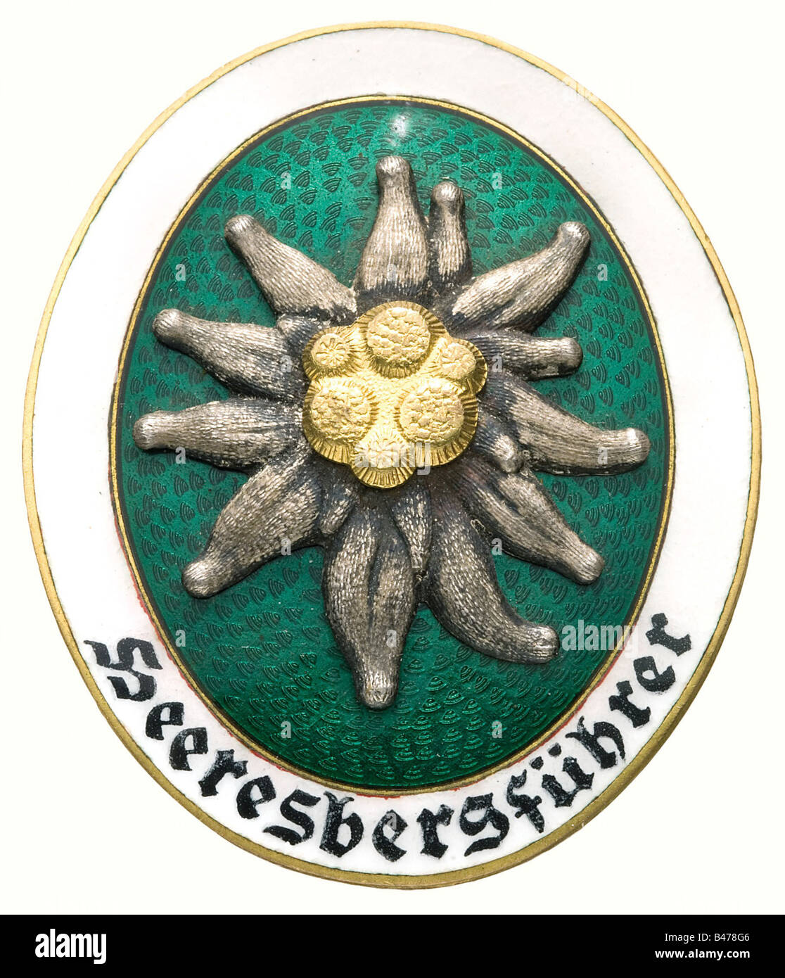 A German Army Mountain Guide Badge., Gilt, non-ferrous metal, the centre of translucent green enamel, white border with hand-painted script, riveted Edelweiss (the rivets repaired with small dots of solder). Vertical oval shape, manufacturer's mark 'Deschler & Sohn München' (OEK 3915/4). historic, historical, 1930s, 1930s, 20th century, awards, award, German Reich, Third Reich, Nazi era, National Socialism, object, objects, stills, medal, decoration, medals, decorations, clipping, cut out, cut-out, cut-outs, honor, honour, National Socialist, Nazi, Nazi period,, Stock Photo